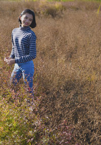 Portrait of girl standing on field