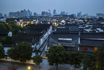 High angle view of illuminated buildings in city at night