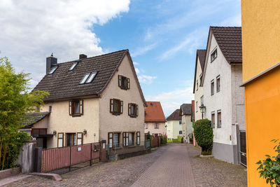 Street amidst buildings against sky