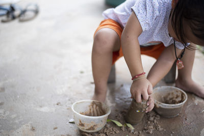 High angle view of boy playing with straw