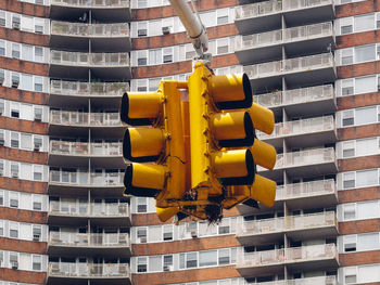 Low angle view of stoplight against buildings