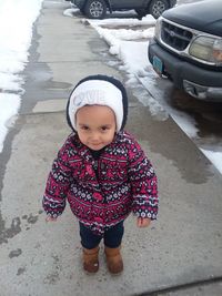 Portrait of cute girl standing in snow