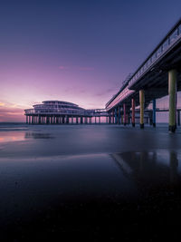 Pier over sea against sky at sunset