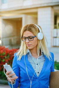 Young woman using mobile phone outdoors