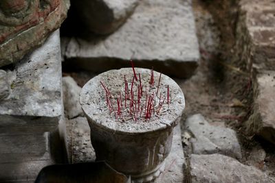 Close-up of old cross on rock