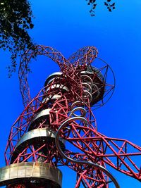 Low angle view of ferris wheel against blue sky