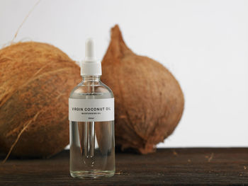 Close-up of dry coconut on table against white background