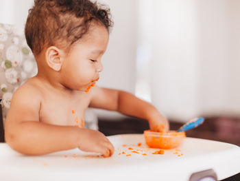 Side view of cute baby eating food