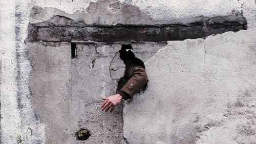 Man's hand in wall