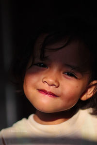 Close-up portrait of smiling cute girl