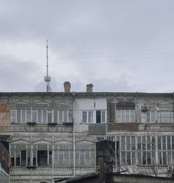 Buildings against cloudy sky