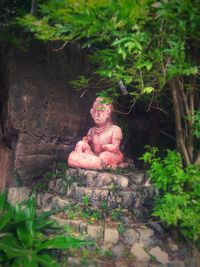 Portrait of teenage girl with tree trunk in forest