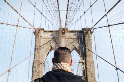 Woman standing on bridge against sky