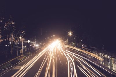 High angle view of light trails on road at night