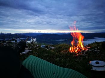 Dog near campfire at sunset