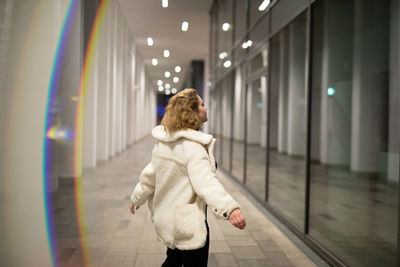 Rear view of woman walking in corridor