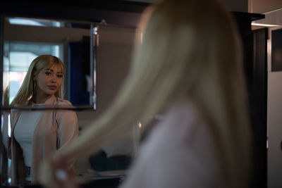 Young woman reflecting on mirror