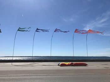 Umbrellas on road against sky in city