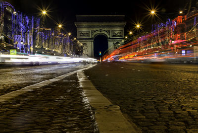 Light trail on street against arc de triomphe