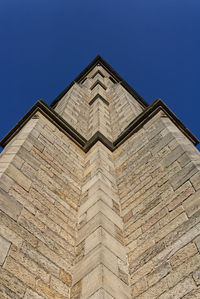 Low angle view of building against clear blue sky