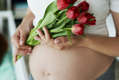 Midsection of woman holding flower bouquet