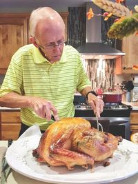 Old man carving turkey