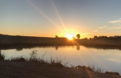 Scenic view of lake against sky during sunset