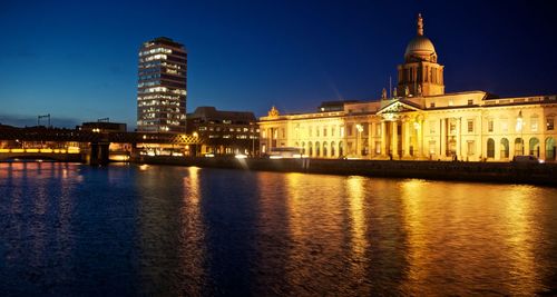 Illuminated custom house by river liffey against sky at night