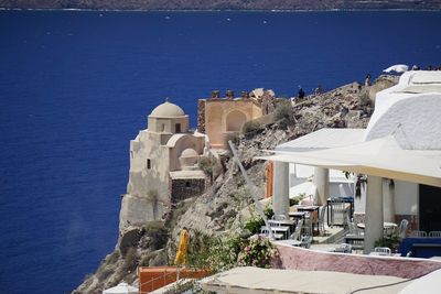 High angle view of buildings by sea