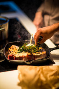 Midsection of man preparing food