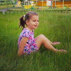 Cute girl smiling on grassy field