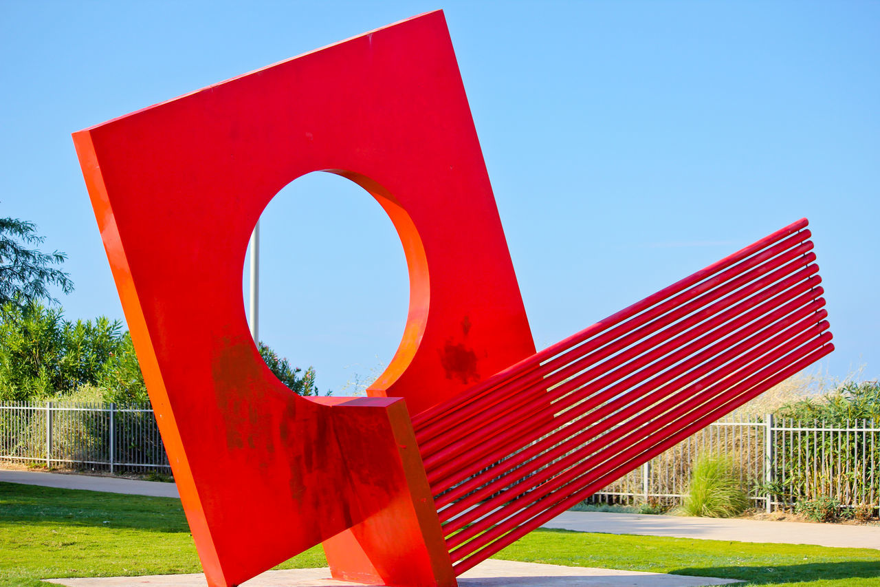 red, sky, nature, blue, clear sky, no people, day, sunny, plant, sunlight, architecture, outdoors, shape, grass, tree, sign, built structure