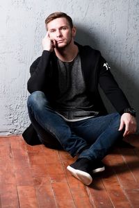 Portrait of young man sitting at home