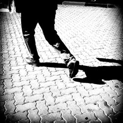 Low section of people standing on tiled floor