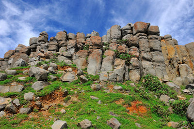 Low angle view of rocks against sky