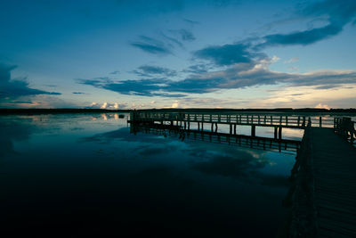 Scenic view of swimming pool against sky at sunset