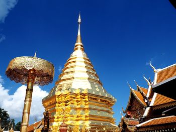 Low angle view of illuminated cathedral against blue sky