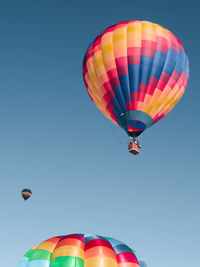 Low angle view of hot air balloons against clear sky