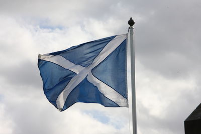 Low angle view of scottish flag waving against sky