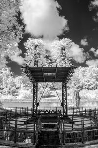 Staircase by water against sky