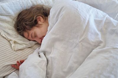 High angle view of baby sleeping in bed