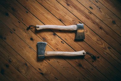 High angle view of axes on wooden table