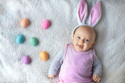 High angle view of cute baby girl with balloons