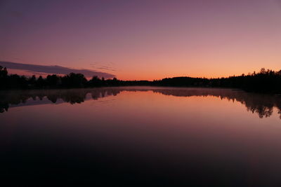 Scenic view of lake against romantic sky at sunset