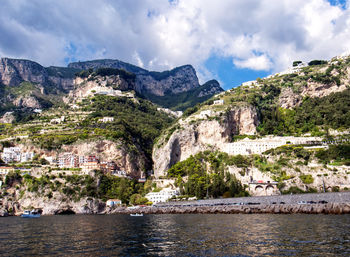 Scenic view of sea and mountains against sky