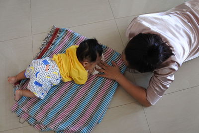 High angle view of women on bed at home