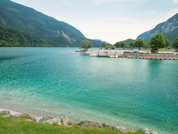 Yacht and paddleboard port at molveno town and molveno lake, an alpine lake in trentino, italy