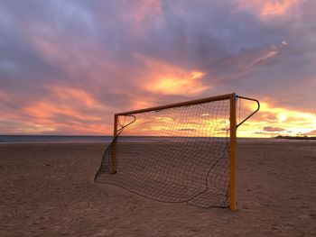 Scenic view of beach against sky during sunset