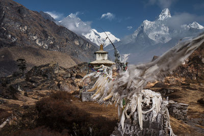 Panoramic view of cross in mountains against sky