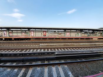 Train at railroad station against sky